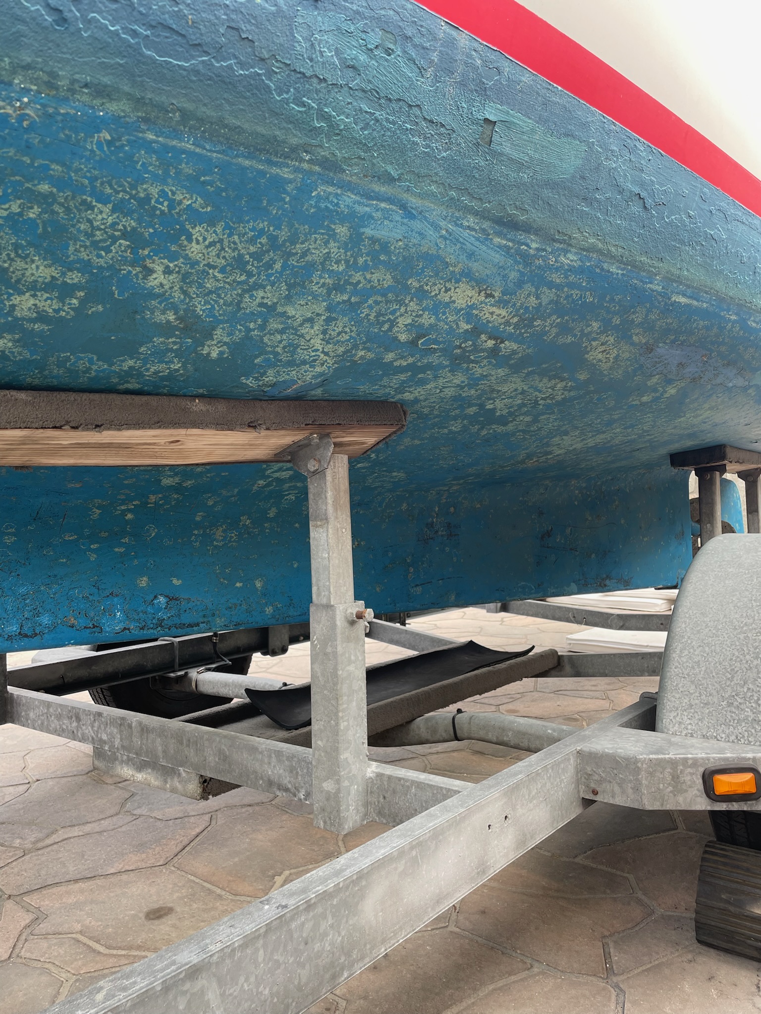 Duffy hull bottom before paint restoration — worn antifouling and prep needs